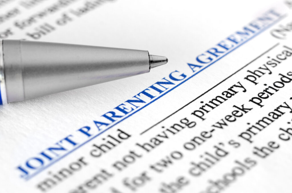 A close up image of a joint parenting agreement, which represents the parenting plan that the attorneys at S.L. Pitts can help with. 
